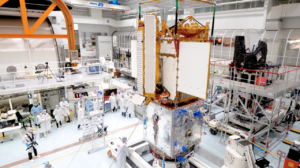 Engineers integrate separate parts of the SWOT satellite into one in a Thales Alenia Space clean room facility in Cannes, France.