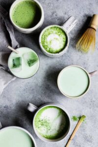 Cups with matcha drinks on a table