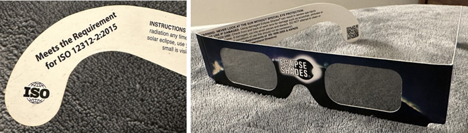 Photos of eclipse glasses showing the certification that they need to have (ISO 12312-2:2015) and what they look like.