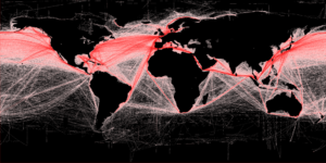 Heat map of shipping lane density across the world's waters. Shipping lanes colored in red against a black background. 